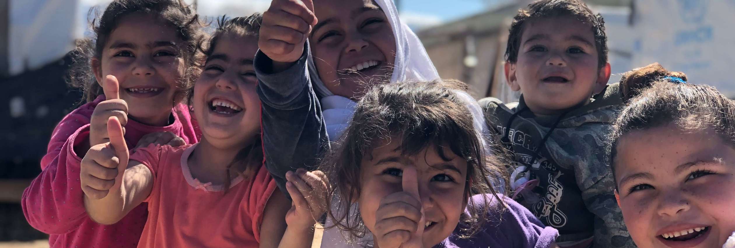 Syrian kids laugh and play at home in their informal settlement in Mhammara, northern Lebanon where 29 families live together with support from UNHCR. 