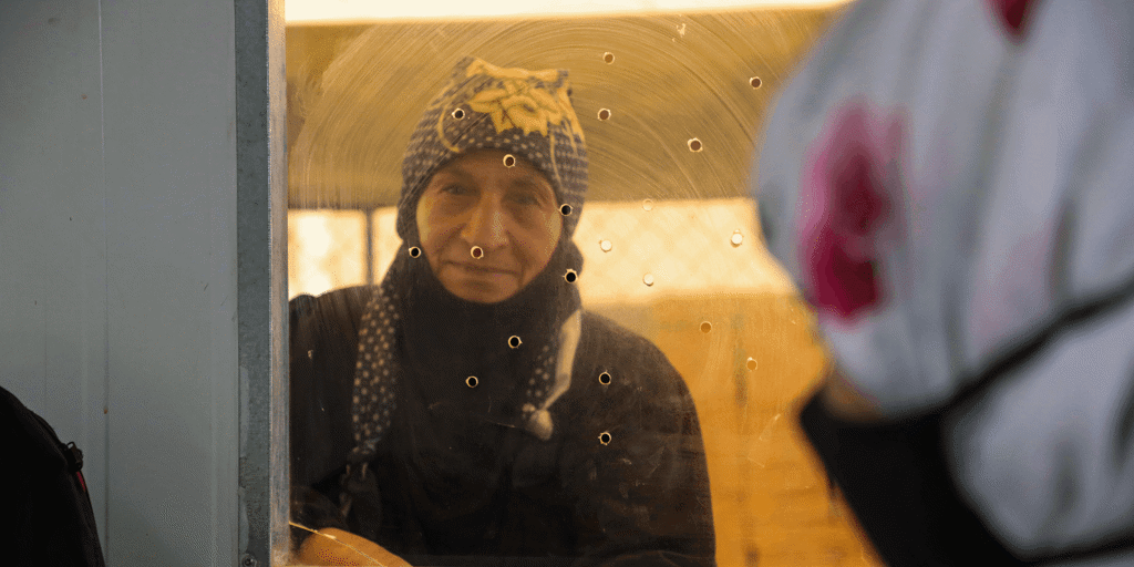 Fandia, 74, receives winter cash assistance from UNHCR during distributions in Za'atari Camp.