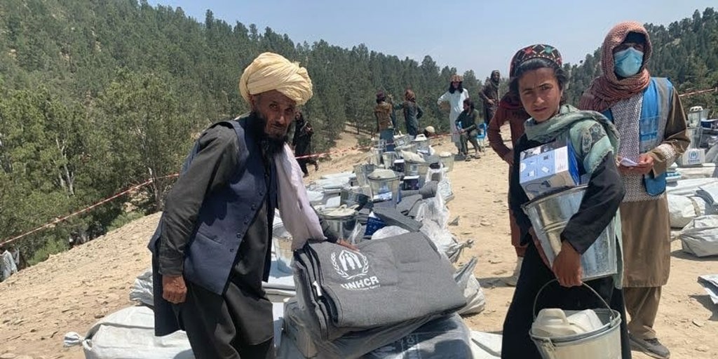 A family collects a relief items kit from the UNHCR distribution point in Khost Province following an earthquake.