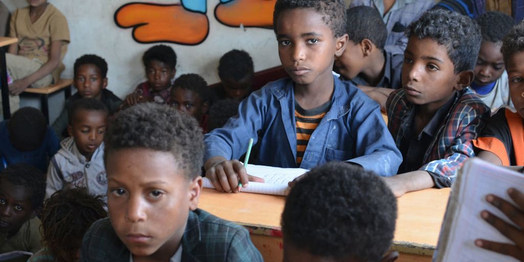Boy sitting in a classroom at a UNHCR-rehabilitated school in Yemen.