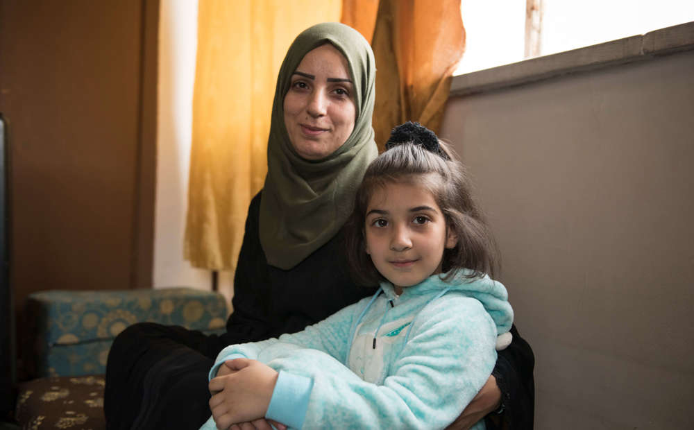 A Syrian refugee mother and her young daughter.