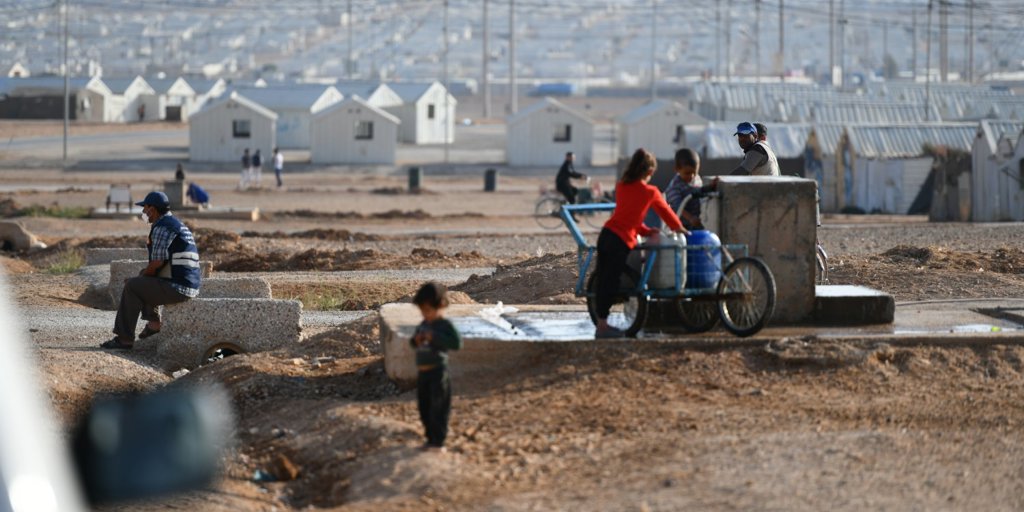 Refugees collect water in Azraq camp in Jordan.