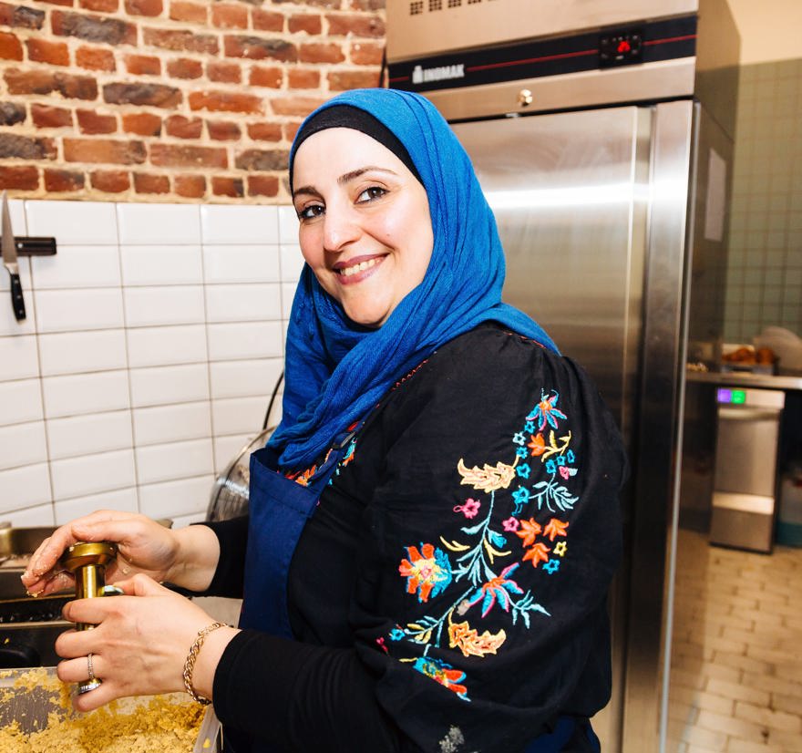 Syrian refugee woman Shahla cooks traditional food in a kitchen in Belgium.