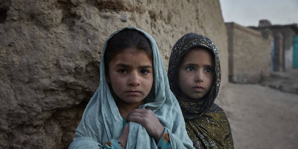 Seven-year-old Runa* from Jalalabad (left) and her friend Gul Bibi*, 7, from Kunduz, in their new neighbourhood on the edge of Kabul.